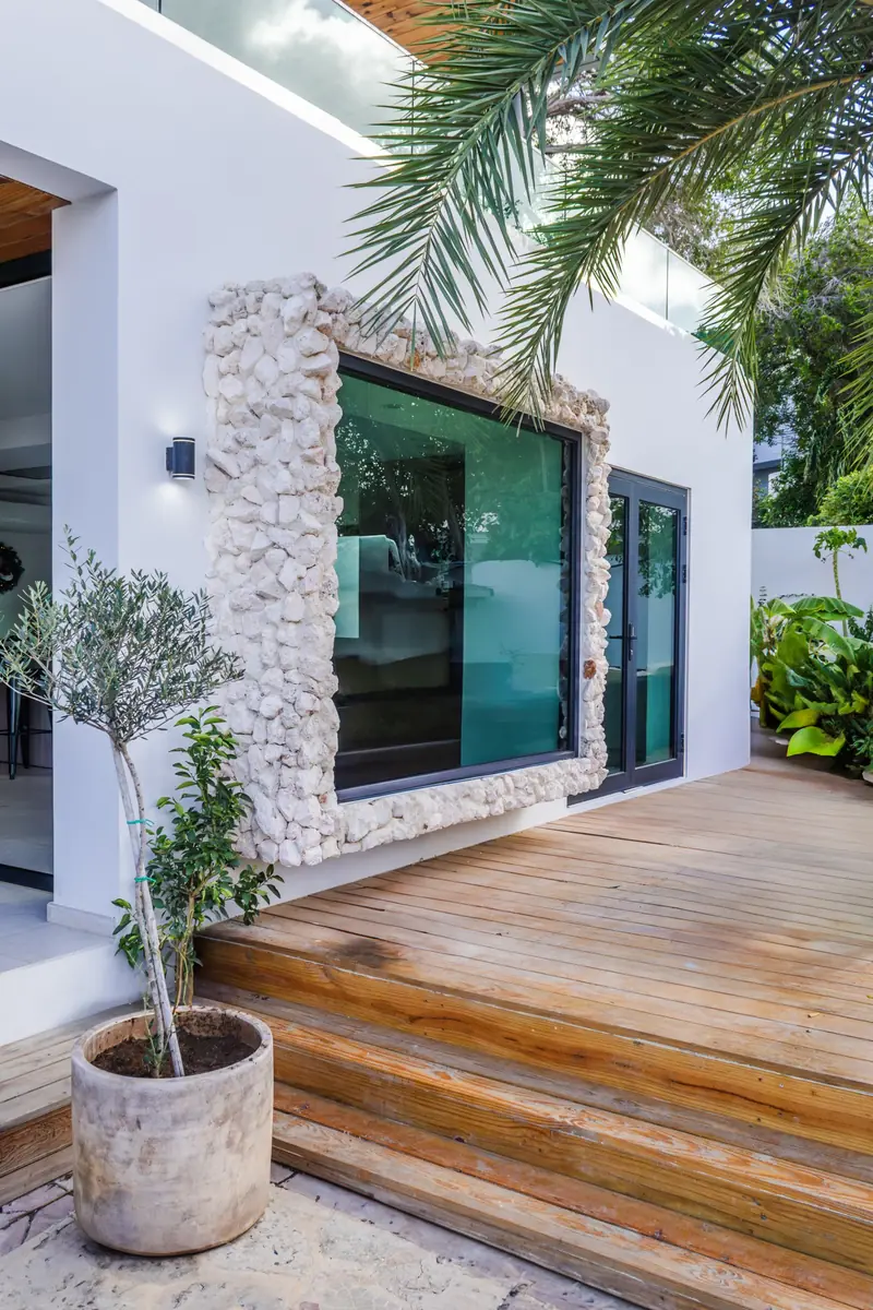White facade with natural stone window frame in Curaçao